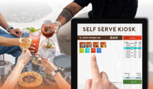 The close-up of someone choosing a drink from a digital screen. In the background are a group of friends enjoying cocktails at a table.